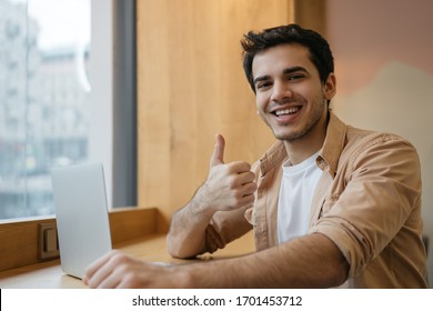 Indian Man Using Laptop Computer, Showing Thumb Up, Looking At Camera And Smiling, Working From Home. Happy Asian Student Studying, Learning Language, Watching Online Training Courses