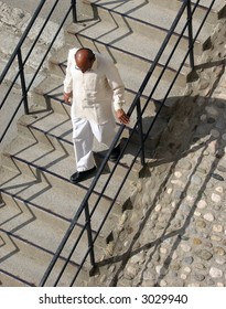 Indian man walking down some stairs