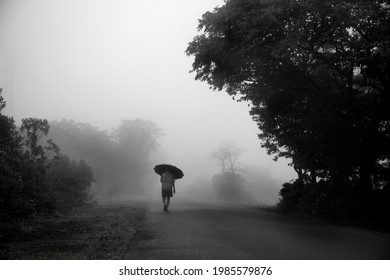 Indian Man Walking In Rain And Mist