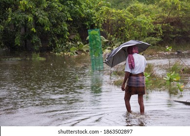 Indian Man Walks Through Flood Water In Chennai