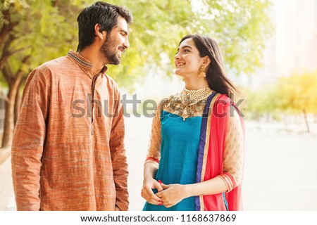 Indian man and woman in traditional clothes talking to each other