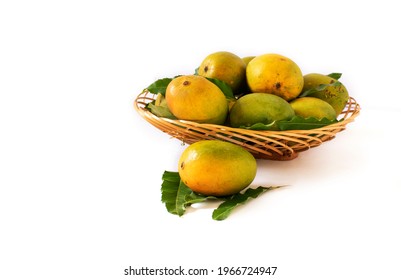 indian mangos in a basket on a white background