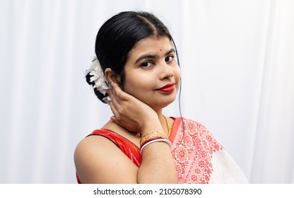 An Indian Married Woman In Red Saree Looking At Camera With Smiling Face On White Background