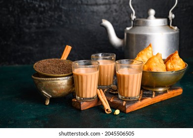 Indian Masala Chai Spice Tea With Kettle, Samosa And Spices On Dark  Background. Cafe, Bar, Restaurant, Hotel Concepts.