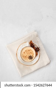 Indian Masala chai tea. Traditional Indian hot drink with milk and spices on white concrete background. Top view, flat lay. Copy space.
