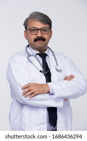 Indian Mature Male Doctor Crossed Arms On White Background.