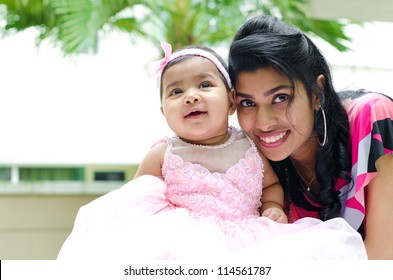 Indian Mother And Baby Girl At Outdoor Home Garden