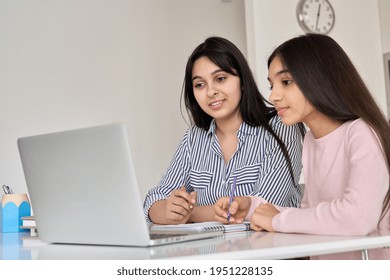 Indian mother helping teen school daughter studying online class, watching video on laptop, zoom virtual school at home. Mum and teenage child girl e learning remote lesson. Distance education.