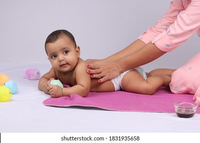 Indian Mother Massaging Her Lovely Baby.