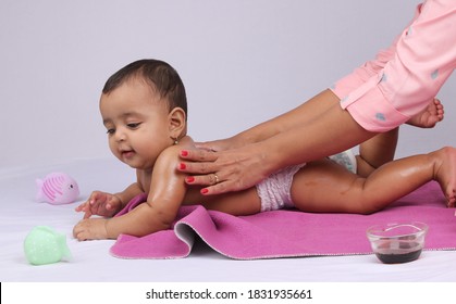 Indian Mother Massaging Her Lovely Baby.