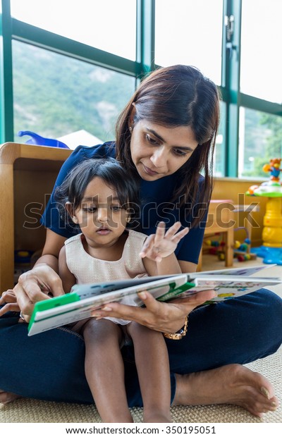 Indian Mother Reading Book Her Daughter Stock Photo (Edit Now) 350195051