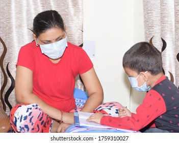 Indian Mother Teaching His Son In Home By Wearing Mask Due To Covid 19 Pandemic