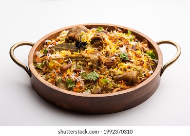 Indian Mutton biryani prepared in Basmati Rice served with Yogurt dip over moody background, Selective focus