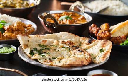 Indian Naan Bread With Herbs And Garlic Seasoning On Plate