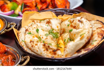 Indian Naan Bread On Wooden Table.