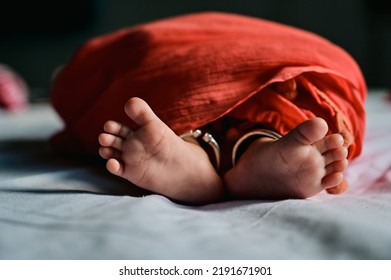 Indian Newborn Baby Feet In Red Cloth Blanket. Happines And Peaceful