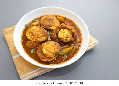 Indian non-vegetarian food- Homemade Egg Curry or Anda masala gravy, baida curry. Indian spicy food. Perfect Indian lunch. over moody background with copy space. - Powered by Shutterstock