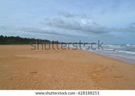 Indian ocean with golden sand, Bentota, Sri Lanka. A wonderful nature landscape of a beach scene.