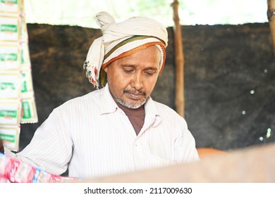 An Indian Old Man Making And Serving Tea At His Tea Shop