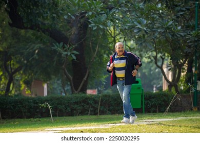 Indian old man running or jogging at park - Powered by Shutterstock