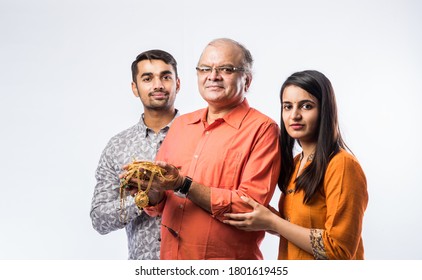 Indian Old Man With Young Son And Daughter Or Couple Holding Gold Jewelry, Ornaments - Asset Or Gold Loan Concept