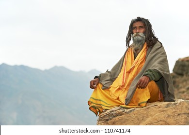 Indian Old Monk Sadhu In Saffron Color Clothing