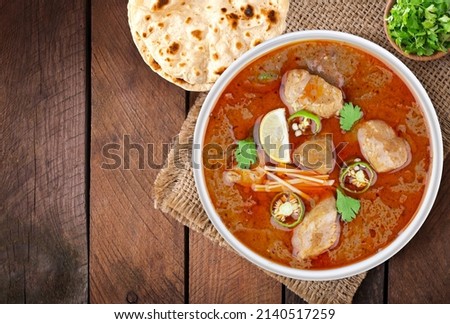 Indian, Pakistani Desi food Nihari with Naan. wooden background.