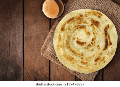 Indian, Pakistani Desi Food Paratha And Chai. Wooden Background.