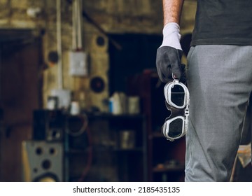 Indian Or Pakistani Worker Holding Welding Safety Goggles Or Safety Gear In Hand At Workshop