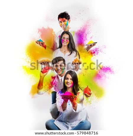 indian people celebrating holi with colours in thali and colour splash