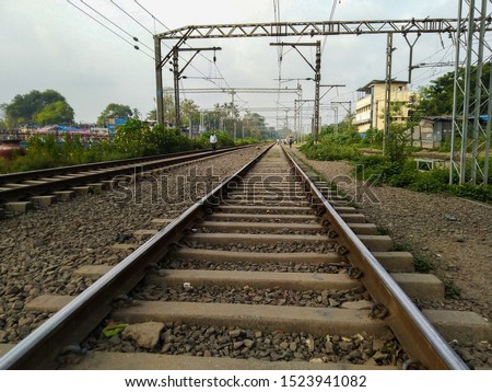 Indian people crossing railway track in mumbai