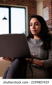 Indian Person Working On Laptop At Home, Attending Online Class Lesson Or Doing Remote Business Work On Computer. Using Wireless Pc To Browse Internet For Research, Virtual Webinar.