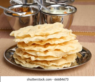 Indian poppadoms with pickle and chutney tray.