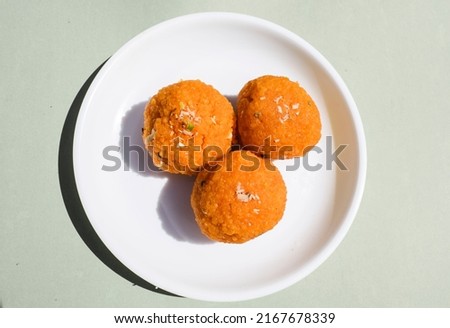 Indian Popular sweet dish item called Motichur Laddu or motichoor ke ladoo made of chickpeaflour or besan batter tiny drops deepfried and then rolled in to sweet balls.Traditionally eating in festival