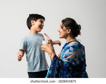 Indian Pretty Mother Making Her Son Drink Milk In A Glass