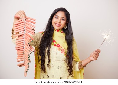 Indian Pretty Young Woman Celebrating Diwali Festival With Fire Crackers.  