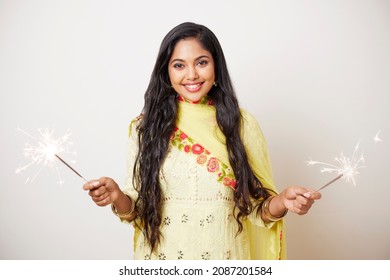 Indian Pretty Young Woman Celebrating Diwali Festival With Fire Crackers.  