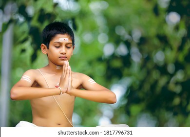 The Indian Priest Child Doing Meditation