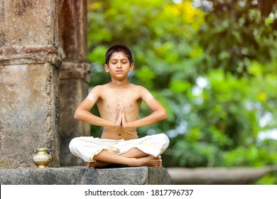 The Indian Priest Child Doing Meditation