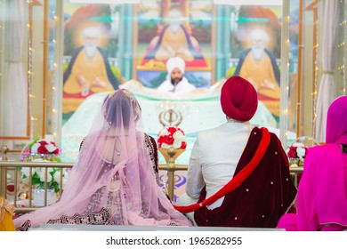 Indian Punjabi Sikh Wedding Ceremony Bride And Groom From The Back