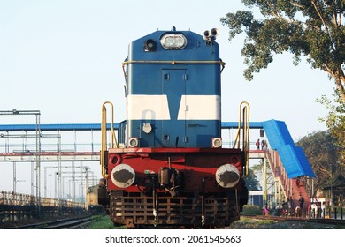 Indian Railways Diesel Locomotive of type WDM3A accelerating hard and passes through a curved track after a scheduled halt at a suburb station.Close front engine view of Indian train running on track.