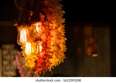 Indian Restaurant Interior With Vintage Light Bulbs. Vintage Village Style Restaurant Lights With Flower And Floral Decoration Concept