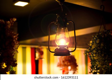 Indian Restaurant Interior With Vintage Light Bulbs. Vintage Village Style Restaurant Lights With Flower And Floral Decoration Concept