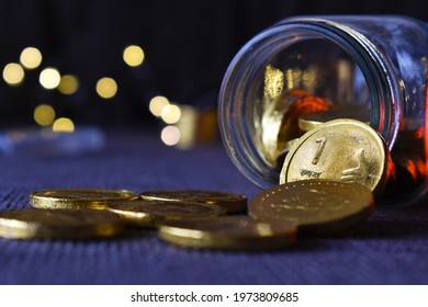 Indian Rupee Coin Placed In Front Of Jar.