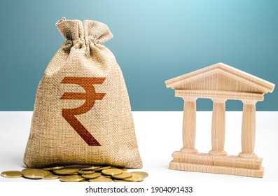 Indian Rupee Money Bag And Bank  Government Building. Budgeting, National Financial System. Resource Allocation. Support Businesses In Crisis. Lending Loans, Deposits. Monetary Policy.