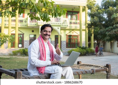 Indian rural farmer using laptop  - Shutterstock ID 1886268670