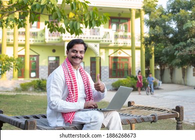 Indian rural farmer using laptop  - Shutterstock ID 1886268673