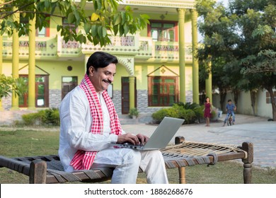 Indian rural farmer using laptop  - Shutterstock ID 1886268676