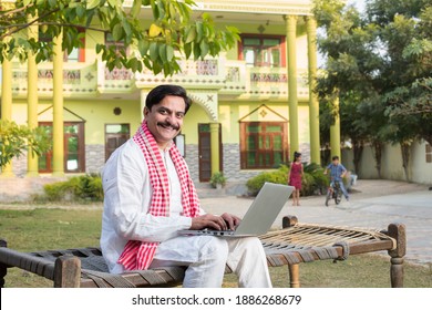 Indian rural farmer using laptop  - Shutterstock ID 1886268679