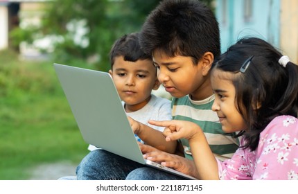 Indian Rural Kids Using Laptop At Outdoor. Concept Of Online Learning, Learn From Home